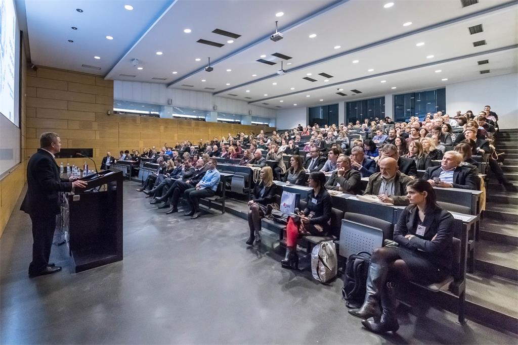 The picture shows an invited lecture by V. Cetl held in the grand hall of the Faculty of Geodesy.